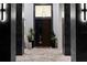Elegant entryway with a stylish front door, modern lighting fixtures, and decorative plants at 2632 Hawthorne St, Sarasota, FL 34239