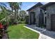 Contemporary home with a well-manicured lawn, modern design elements, and a paver walkway at 2632 Hawthorne St, Sarasota, FL 34239