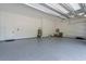 Spacious three car garage with epoxy flooring, ample storage space, and an automatic door at 2632 Hawthorne St, Sarasota, FL 34239