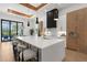 Well-lit kitchen with island seating, opening to the outdoor dining area at 2632 Hawthorne St, Sarasota, FL 34239