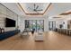 Open-concept living room with modern furnishings, a large TV, and seamless access to the outdoor pool area at 2632 Hawthorne St, Sarasota, FL 34239