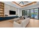 Bright living room featuring a sleek entertainment center, modern decor, and access to the outdoor pool area at 2632 Hawthorne St, Sarasota, FL 34239