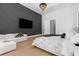 Bright bedroom featuring modern decor and a view of the TV on a stylish accent wall at 2632 Hawthorne St, Sarasota, FL 34239