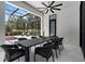 Outdoor dining area featuring a large table, comfortable seating, and scenic views of the screened pool area at 2632 Hawthorne St, Sarasota, FL 34239