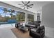 Contemporary outdoor living space with a seating area, dining area, and a view of the sparkling pool at 2632 Hawthorne St, Sarasota, FL 34239