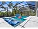 Stunning screened-in pool with hot tub, in-pool seating, and lush landscaping at 2632 Hawthorne St, Sarasota, FL 34239