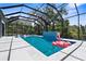 Beautiful screened-in pool with tiled waterfall feature and a fun, pink flamingo float at 2632 Hawthorne St, Sarasota, FL 34239