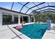 Stunning screened-in pool area with outdoor kitchen, dining, and entertaining space at 2632 Hawthorne St, Sarasota, FL 34239