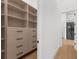 Custom walk-in closet with built-in shelving, drawers, and access to a modern bathroom at 2632 Hawthorne St, Sarasota, FL 34239