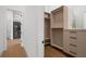 Walk-in closet with custom shelving, drawers, and direct access to the bathroom at 2632 Hawthorne St, Sarasota, FL 34239