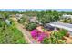 Aerial view of property backing up to waterway with a screened in patio and lush, colorful foliage at 3036 Rose St, Sarasota, FL 34239
