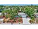 Aerial view showcasing the home, surrounding trees, lush landscaping, and neighborhood at 3036 Rose St, Sarasota, FL 34239