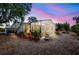 Backyard features a screened-in lanai surrounded by lush landscaping and potted plants at sunset at 3036 Rose St, Sarasota, FL 34239