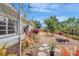 This home has a beautiful backyard surrounded by trees, plants and flowers at 3036 Rose St, Sarasota, FL 34239