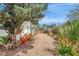Landscaped backyard featuring a vibrant garden and gravel pathway at 3036 Rose St, Sarasota, FL 34239