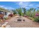 The backyard landscaping showcases a firepit and relaxing space surrounded by lush greenery and colorful flowers at 3036 Rose St, Sarasota, FL 34239