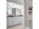 Bathroom showcasing white cabinets, granite countertop, and shower with tiled accents at 3036 Rose St, Sarasota, FL 34239