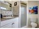 Bathroom with tiled walls, granite countertop, and a walk-in shower at 3036 Rose St, Sarasota, FL 34239