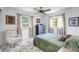 Relaxing bedroom features a ceiling fan and bright natural light through the windows at 3036 Rose St, Sarasota, FL 34239
