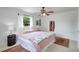Cozy bedroom with ceiling fan, vintage rugs, and a window with a bright view at 3036 Rose St, Sarasota, FL 34239