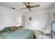 Bright bedroom features a ceiling fan, closet, and bright natural light through the windows at 3036 Rose St, Sarasota, FL 34239