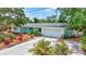 Well landscaped single Gathering home with a two car garage and baby blue shutters on this charming home at 3036 Rose St, Sarasota, FL 34239