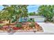 Charming home with lush landscaping, colorful bromeliads, and a well-manicured lawn at 3036 Rose St, Sarasota, FL 34239