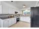 Bright kitchen featuring granite countertops, stainless steel appliances and white cabinetry at 3036 Rose St, Sarasota, FL 34239