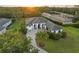 Aerial view of a beautiful home with a well-manicured lawn and a paved driveway leading to the entrance at 3415 162Nd E Ave, Parrish, FL 34219
