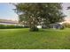 Spacious backyard featuring mature trees, offering shade and a tranquil setting for outdoor enjoyment at 3415 162Nd E Ave, Parrish, FL 34219