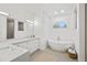 Bright bathroom boasts dual sinks, soaking tub, and stone floors at 3415 162Nd E Ave, Parrish, FL 34219