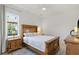 Bedroom with a wooden bed frame, two nightstands, and a large window at 3415 162Nd E Ave, Parrish, FL 34219
