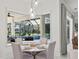 Dining area with chandelier overlooks outdoor pool and lanai at 3415 162Nd E Ave, Parrish, FL 34219