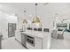 Open kitchen with an expansive island, stainless steel appliances, and views into the dining area at 3415 162Nd E Ave, Parrish, FL 34219