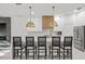 Stylish kitchen with a white quartz island, pendant lighting, and a stainless-steel refrigerator at 3415 162Nd E Ave, Parrish, FL 34219