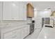 Bright kitchen features white cabinets, stainless appliances, and stone countertops at 3415 162Nd E Ave, Parrish, FL 34219