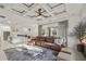 Open-concept living area with a coffered ceiling, modern furnishings, and a view of the gourmet kitchen at 3415 162Nd E Ave, Parrish, FL 34219
