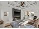 Living area showcasing a statement fireplace with a flat-screen TV, and an open layout to the kitchen at 3415 162Nd E Ave, Parrish, FL 34219