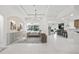 Spacious living room with white tile floors, tray ceilings, a large window, and a bar area at 3415 162Nd E Ave, Parrish, FL 34219