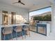 A covered outdoor kitchen boasts a built-in grill, bar seating, and ample space for entertaining by the pool at 3415 162Nd E Ave, Parrish, FL 34219