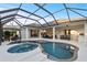 Inviting screened-in pool and spa area featuring comfortable lounge furniture, bar seating, and seamless indoor-outdoor living at 3415 162Nd E Ave, Parrish, FL 34219