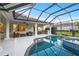 Gorgeous screened-in pool with an attached spa and a covered patio with an outdoor kitchen at 3415 162Nd E Ave, Parrish, FL 34219