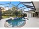 Backyard oasis showcases a sparkling pool and spa enclosed within a screened lanai for year-round enjoyment and privacy at 3415 162Nd E Ave, Parrish, FL 34219