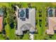 Aerial view of a home showcasing a pool, manicured landscaping, and a grey tile roof at 356 Blackbird Ct, Bradenton, FL 34212