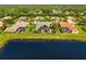 Aerial view of homes with pools overlooking a pond in a quiet neighborhood at 356 Blackbird Ct, Bradenton, FL 34212