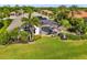 Lush backyard featuring a screened-in pool area surrounded by tropical landscaping at 356 Blackbird Ct, Bradenton, FL 34212