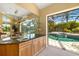 Bar area overlooking the screened lanai and pool at 356 Blackbird Ct, Bradenton, FL 34212