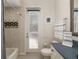 Bright bathroom boasts a navy blue vanity, large mirror, and a door to the outside at 356 Blackbird Ct, Bradenton, FL 34212