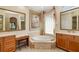 Bathroom featuring jacuzzi tub, vanity area, and decorative lighting at 356 Blackbird Ct, Bradenton, FL 34212