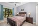 Bedroom featuring a wooden frame bed, bedside tables, and window with a lake view at 356 Blackbird Ct, Bradenton, FL 34212